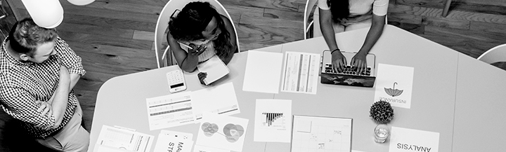 Woman and two men meeting at a table