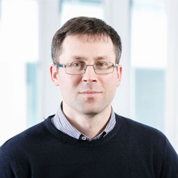 a man wearing glasses posing for the camera