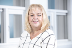 a woman standing in front of a window