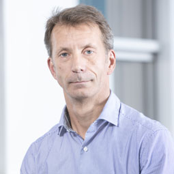 Francis Smerecki standing in front of a building