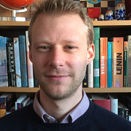 Jakob Von Eichel standing in front of a book shelf