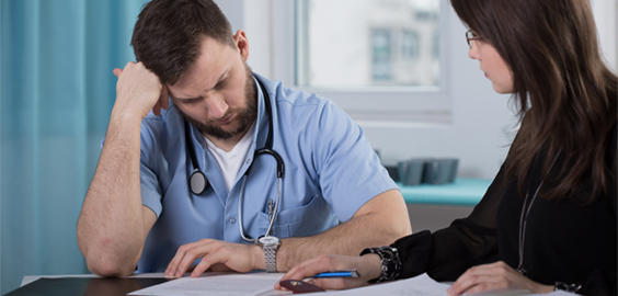 a man and a woman sitting on a table