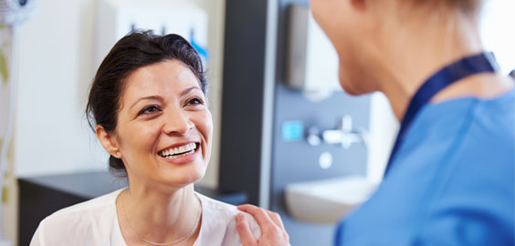 Female patient smiling up at male nurse