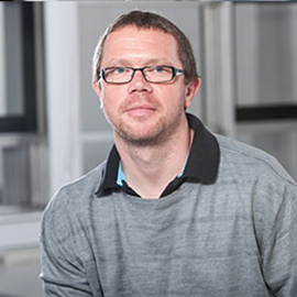 a man standing in front of a building