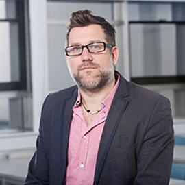 a man standing in front of a building