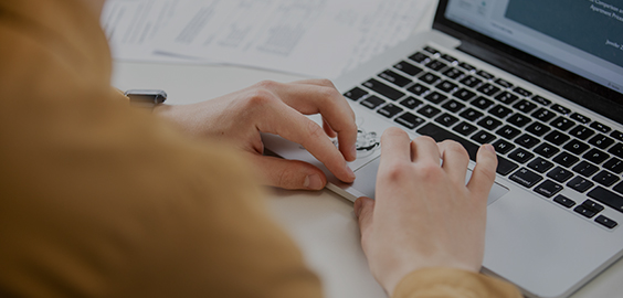 Person scrolling and using a laptop