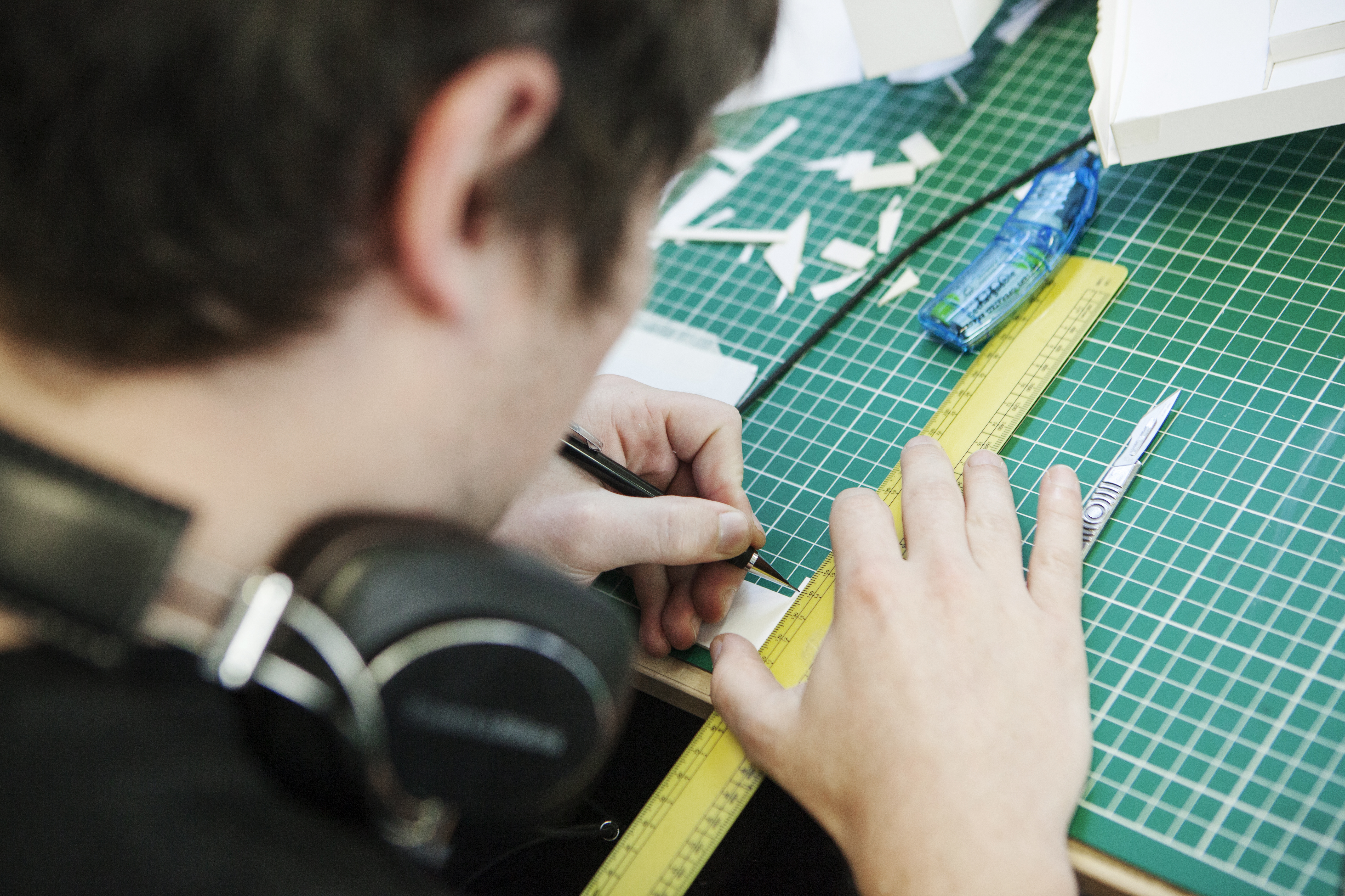 student using tools to measure for an architecture model