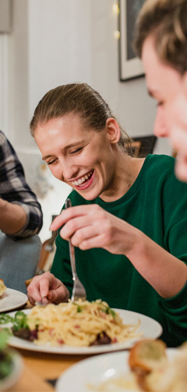 a person sitting at a table eating food