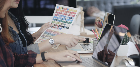 a woman sitting at a table using a laptop