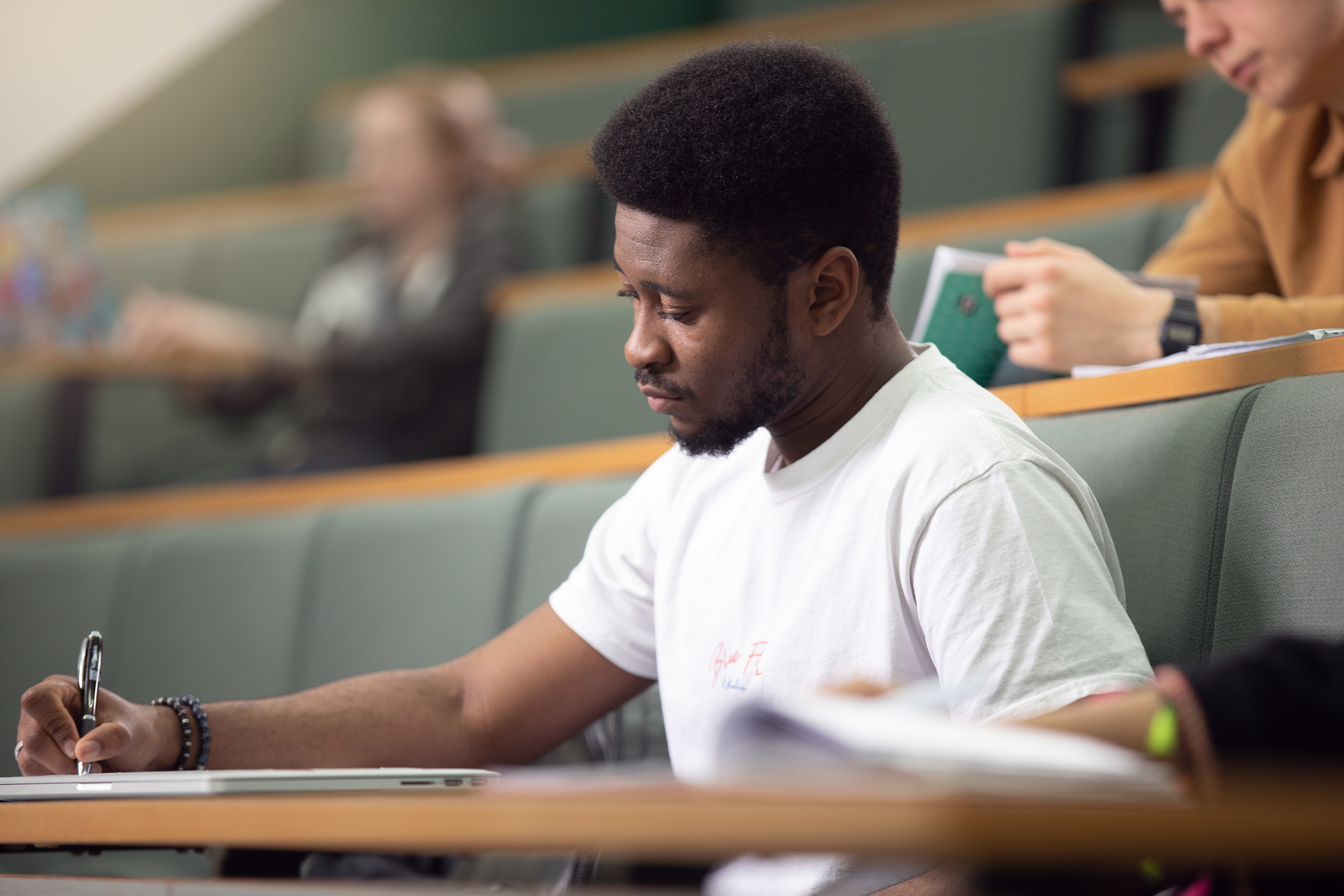 student in lecture writing