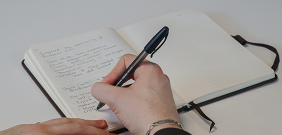 student writing in notebook