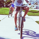 a person riding on the back of a bicycle