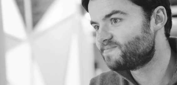 a man wearing glasses and looking at the camera