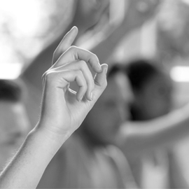 a close up of a womans face with her hand to her face