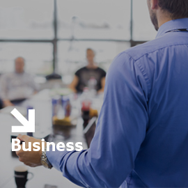 a man standing in front of a blue wall