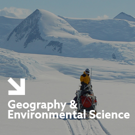 a man riding on top of a snow covered mountain