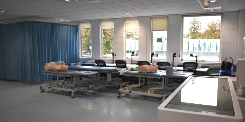 Medical teaching space with mock wards and cpr models.