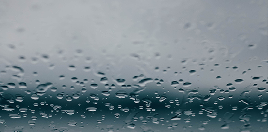 Raindrops against a blue and grey backdrop