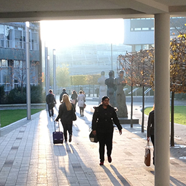 a group of people walking on a sidewalk