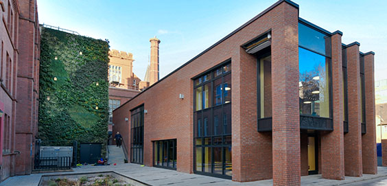 a large brick building with a store on the corner of a street