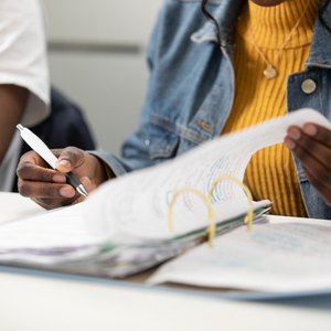 Person writing in a note book