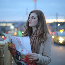 young tourist woman looking at a navigation map
