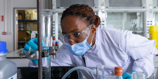 young female student using equipment in the lab