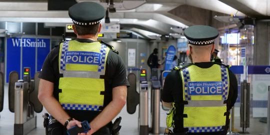 two police officers in yellow reflective jackets standing