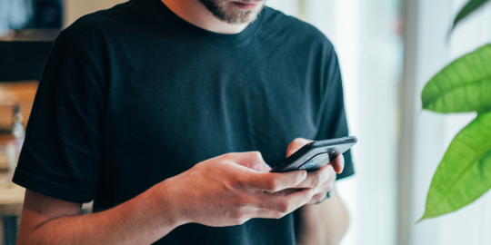 Close up of man using his smart phone