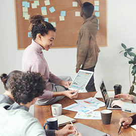group of people in office looking at laptop