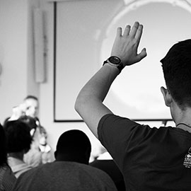 student with hand raised