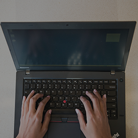 IT Account: Log in and Learn page menu button - a person typing on a laptop.