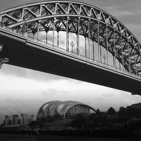 a train crossing a bridge over a body of water
