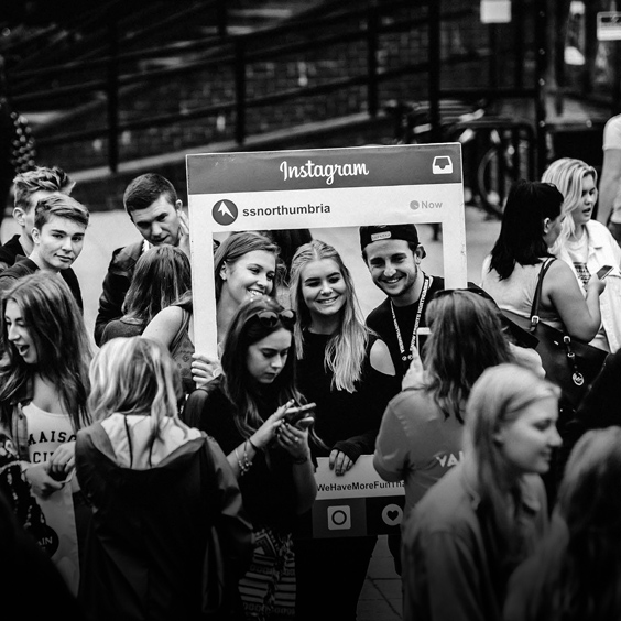a group of people standing in front of a crowd posing for the camera