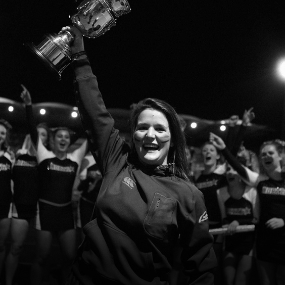 a person standing in front of a crowd posing for the camera
