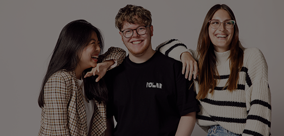 Three students smiling