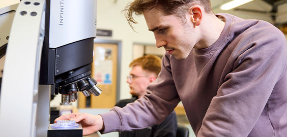 male student working on lab equipment