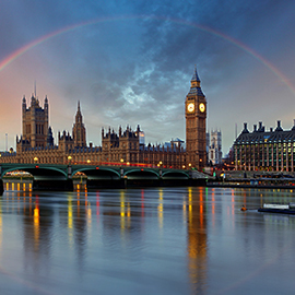 a bridge over water with a city in the background