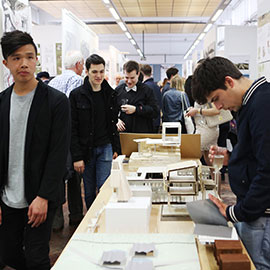 a group of people standing around a table