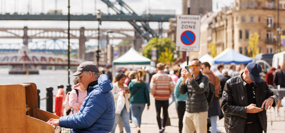 person playing the piano along the quayside