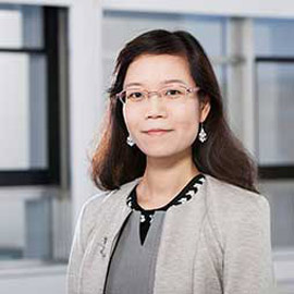 a woman standing in front of a window