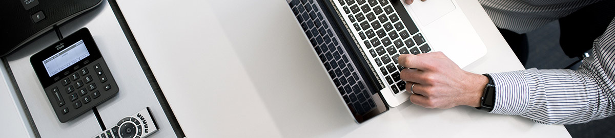 a hand holding up a laptop computer