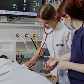 Nursing student and academic working on practice patient