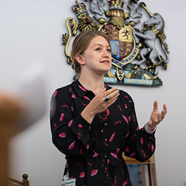 a woman standing in front of a statue