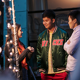 a group of people standing around each other