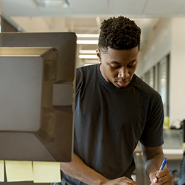 a man standing in a kitchen preparing food
