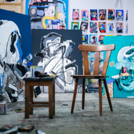 Art feature with paintings and chair outside