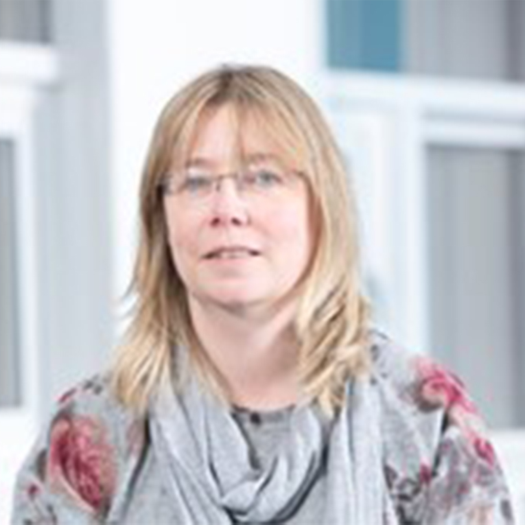 a woman standing in front of a building