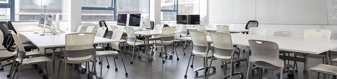 Image of classroom with tables, chairs and computers