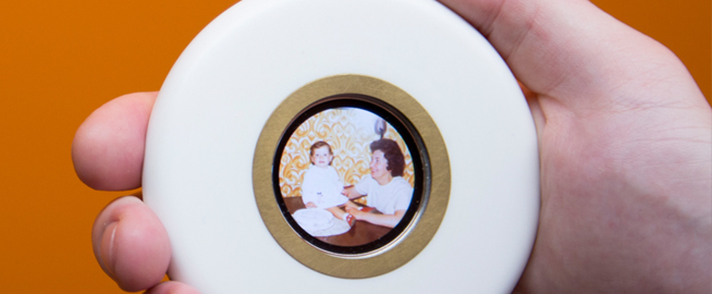 Hand holding image of mother and baby